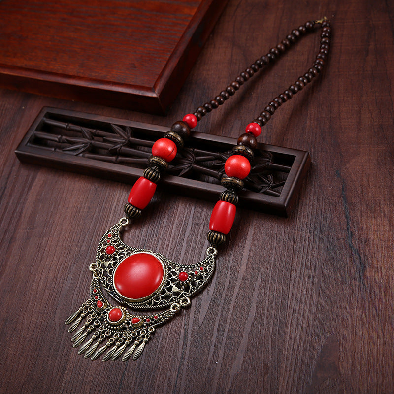 A dual-purpose exaggerated pendant necklace and sweater chain with ethnic style hidden accessories