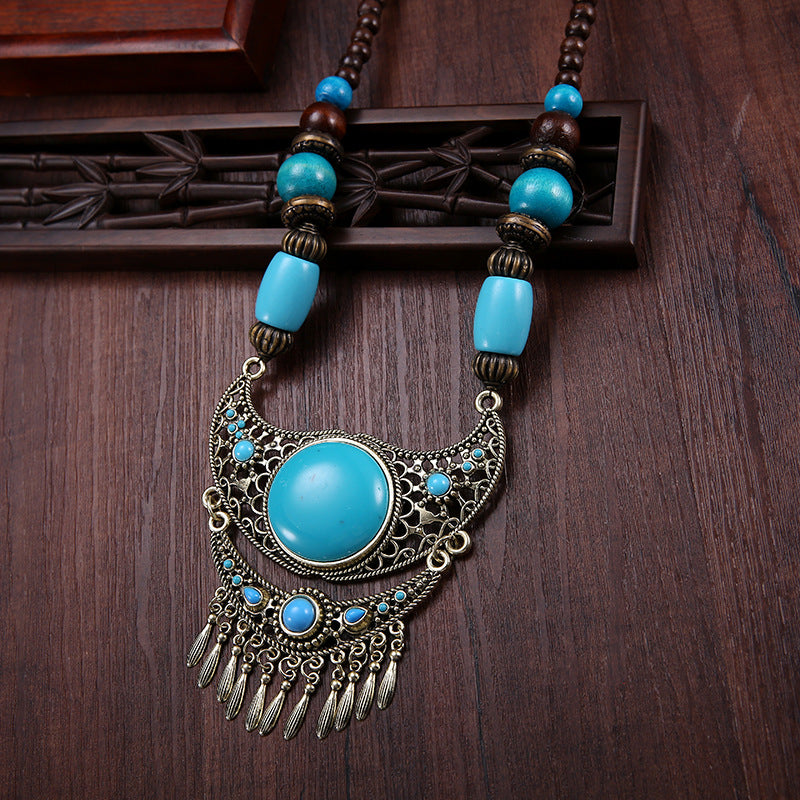 A dual-purpose exaggerated pendant necklace and sweater chain with ethnic style hidden accessories