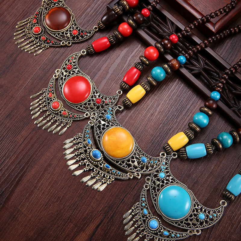 A dual-purpose exaggerated pendant necklace and sweater chain with ethnic style hidden accessories